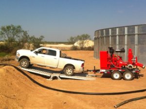 Pickup truck driving over a fracking ramp